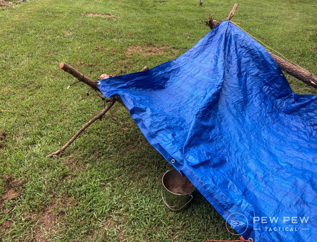 Simple tarp shelter that feeds caught moisture into a bucket